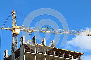Big yellow stationary hoist on construction site