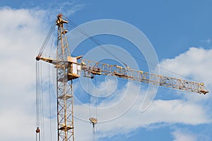 Big yellow stationary hoist on construction site