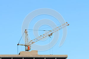 Big yellow stationary hoist on construction site