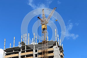 Big yellow stationary hoist on construction site