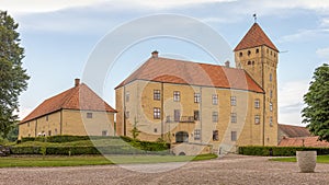 The big yellow Tosterup castle in three floors with a tall tower from the 1500s