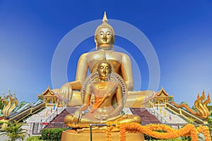 biggest golden buddha statue in wat muang public temple at angthong province, thailand