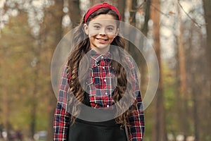 Biggest Hair Accessory Trends. Adorable little girl checkered shirt wear red headband. Fashion trend. Accessories. Fancy
