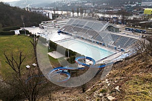 Biggest swimming complex with indoor and outdoor pools, toboggan water slide and diving towers with Vltava river in background