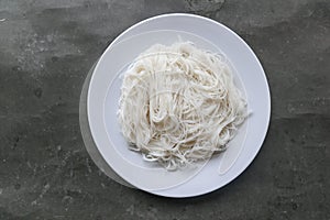 Bihun or vermicelli or rice noodles or angel hair served on plate isolated on black background.