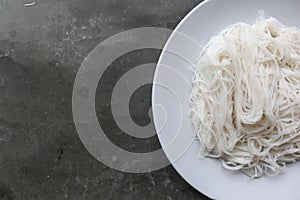 Bihun or vermicelli or rice noodles or angel hair served on plate isolated on black background.