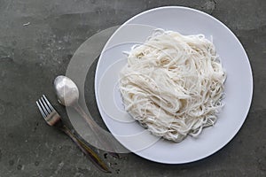 Bihun or vermicelli or rice noodles or angel hair served on plate isolated on black background.