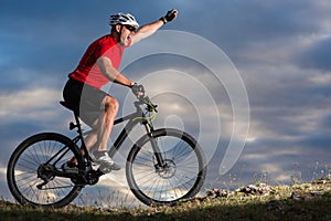 Bike adventure travel photo. Bike tourists ride on the countryside downhill.