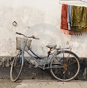 Bike against wall at sunset