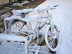 Bike at bike rack, snowed, covered in snow