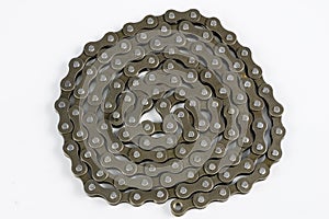 Bike chain arranged on a white table. Periodic servicing of part