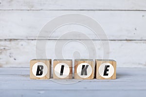 bike concept written on wooden cubes or blocks, on white wooden background.