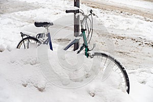 Bike covered in snow during snow storm