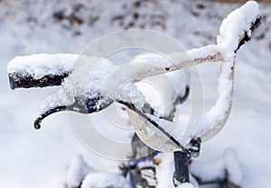 The bike is covered with snow in the winter