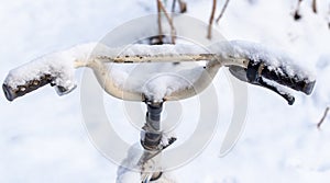 The bike is covered with snow in the winter