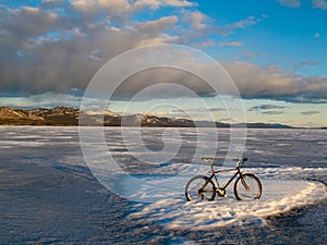 Bike on frozen Lake Laberge, Yukon, Canada