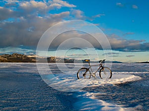 Bike on frozen Lake Laberge, Yukon, Canada