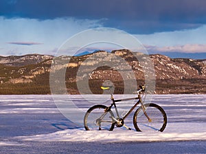 Bike on frozen Lake Laberge, Yukon, Canada