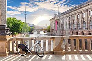 Bike in a good weather on the Bridge over the river Spree in Berlin near the TV tower and museums, Germany