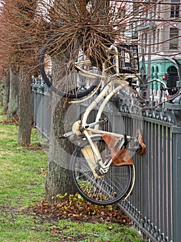 Bike hanging in a large fence