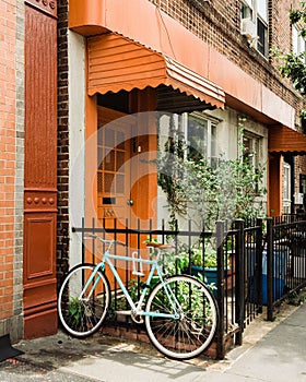 Bike and house with orange door in Greenpoint, Brooklyn, New York City