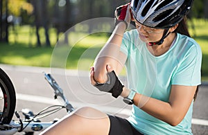 Bike injuries. Woman cyclist fell off road bike while cycling. Bicycle accident, injured back