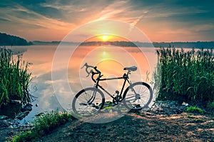 Bike on the lake at sunrise.