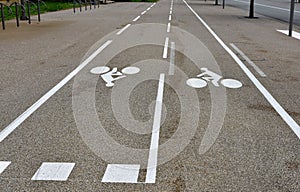 Bike lanes or cycle paths in opposite directions along the car road in the city of Belfort in France.