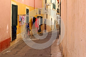 Bike laundry drying shutters corridor colorful, Puglia, Italy