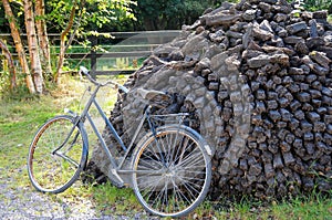Bike leaning against a heap of dried peat