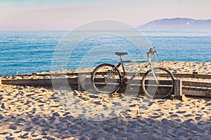 Bike parked on the beach, Su Barone beach in Sardinia, Italy, near to Orosei, active way of spending time and vacation