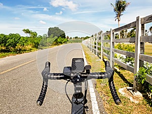 Bike parked beside open road with blue sky. Freedom and transportation concept