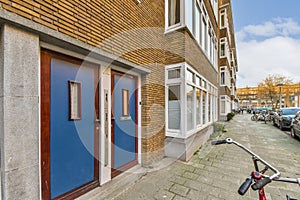 a bike parked outside a building with a blue door