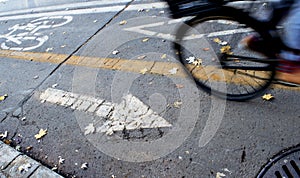 Bike path in city with bicycle wheel in motion