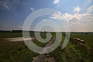 Bike path on an enbankment in the middle of the fields in the italian countryside in summer