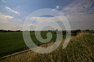 Bike path on an enbankment in the middle of the fields in the italian countryside in summer