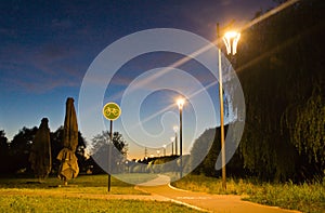 Bike path in evening park in summer