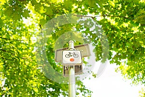 bike path sign in city park. Alerting pedestrians about the movement of cyclists. Cycling infrastructure.