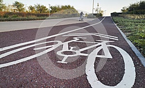 Bike path. Sign white paint on the pavement. Summer. bicycle traffic sign painted on the floor