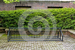 Bike Rack and bush against building