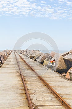 Bike on rail in breakwater at Cassino beach