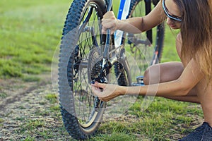 Bike repair. Young girl repairing mountain bike