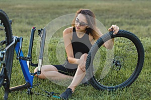 Bike repair. Young girl repairing mountain bike