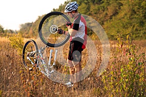 Bike repair. Young man repairing mountain bike