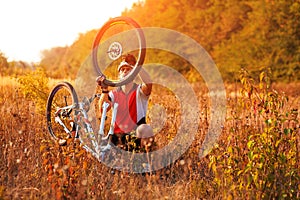 Bike repair. Young man repairing mountain bike