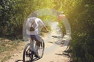 A bike ride in the park. Two cyclists with backpacks