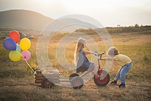 Bike riding - children on bike. Farming and agriculture cultivation. Active family leisure with kids. sweet childhood