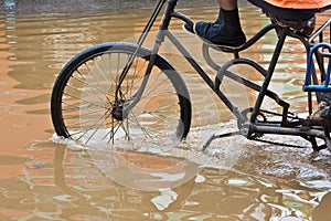 Bike riding through flooded streets