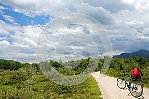 Bike riding at isar wetlands, with dramatic cloudy sky, lonely b