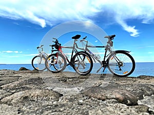 Biking mountain biking on bike on rock stone ,Biking mountain on horizon blue sky  white clouds nature panorama seascape landscape